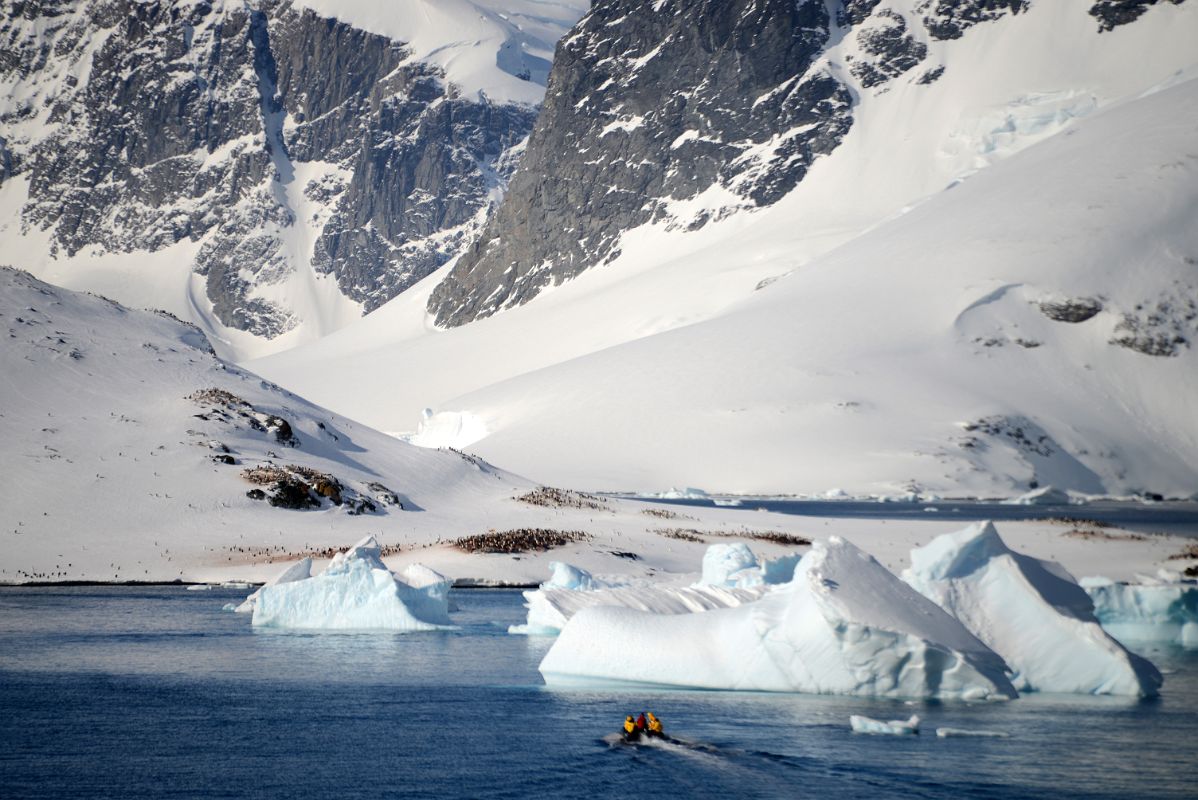 08E Zodiac Almost To A Penguin Colony On Cuverville Island With Mountains On Ronge Island Towering Behind From Quark Expeditions Antarctica Cruise Ship